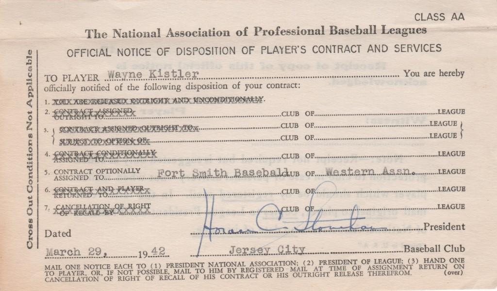 Horace Stoneham signs reassignment document for a minor leaguer