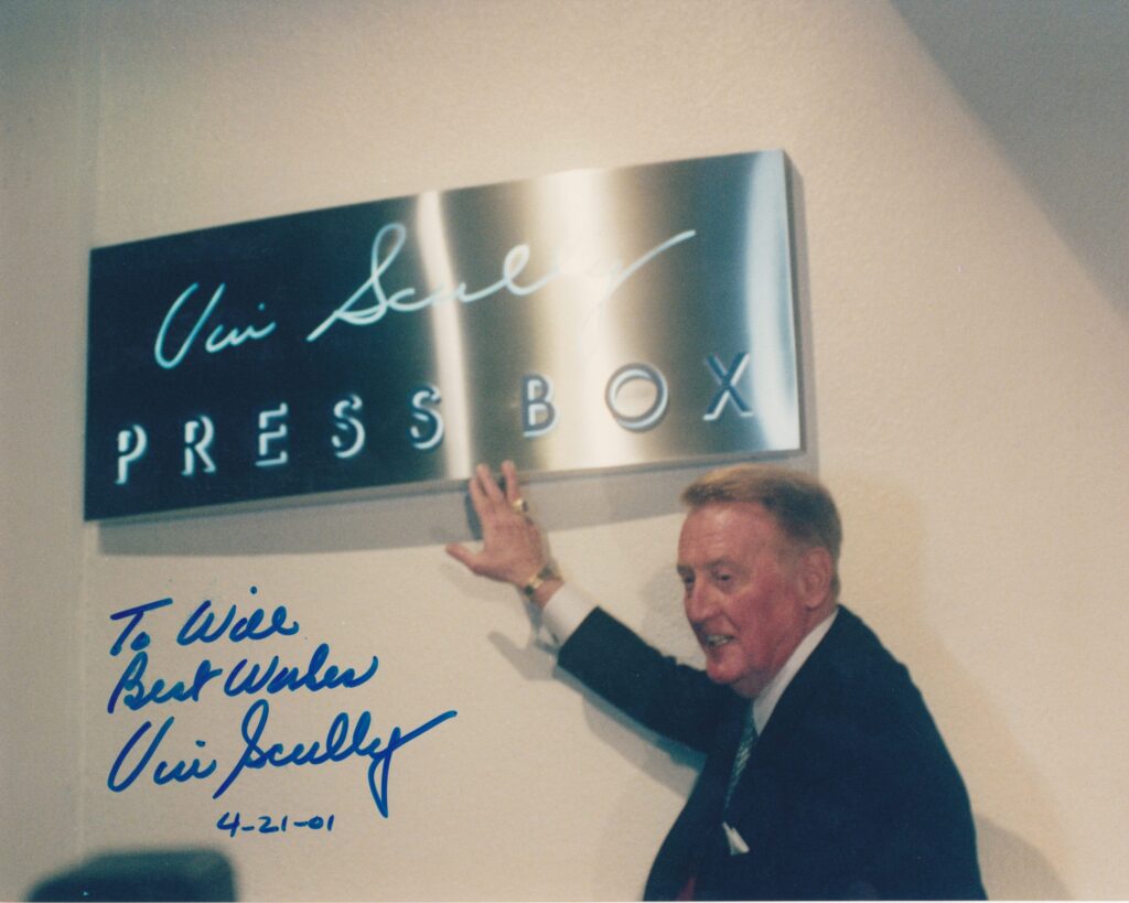 Scully climbed a ladder to unviel the sign outside the press box now named after him